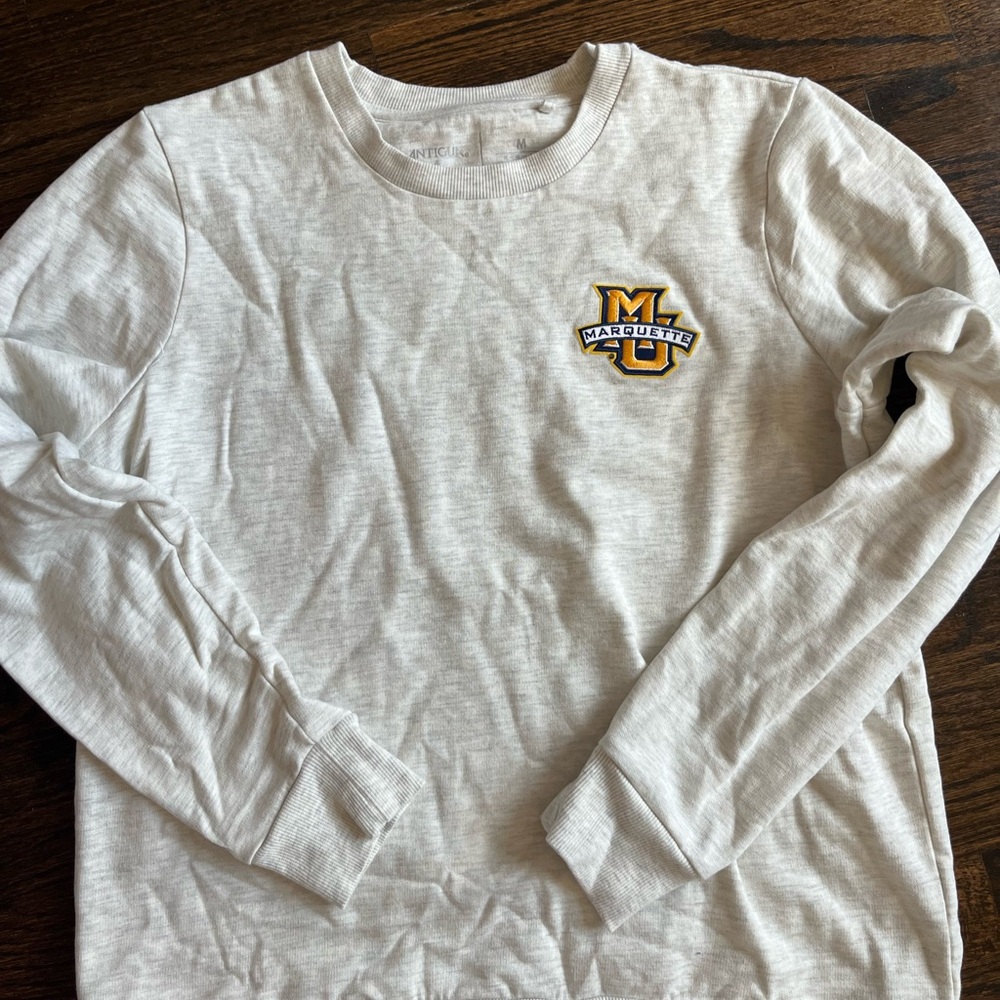 Antigua Marquette Cream Crewneck Sweatshirt with Gold & Blue Logo